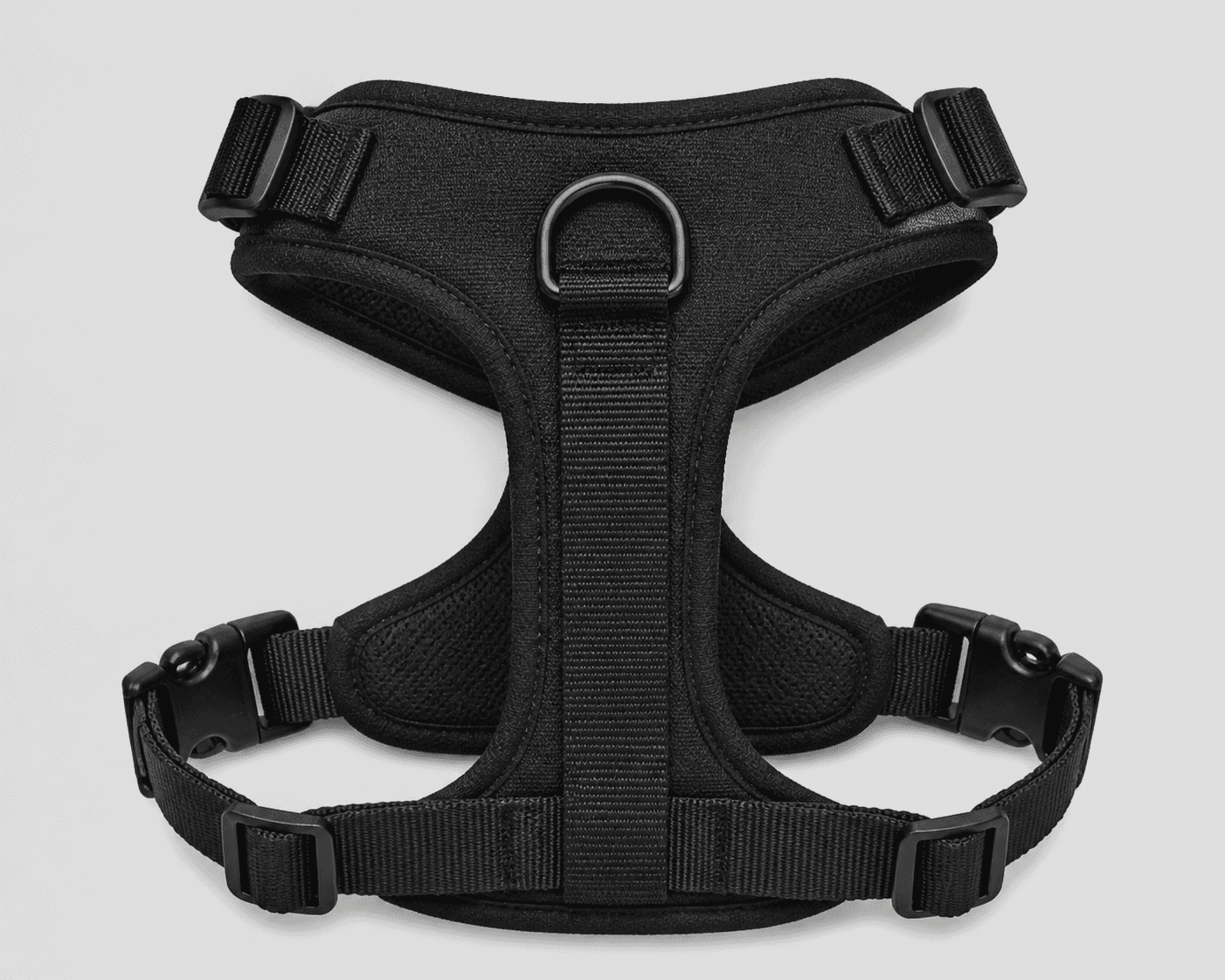 Black adjustable dog walking harness shown flat with padded body, webbing straps, side adjusters, buckles, lower adjustment hardware, and centered back D-ring visible